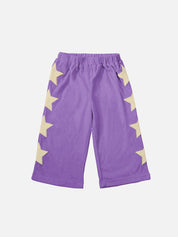 A pair of purple children's pants with a pattern of yellow stars down the side.