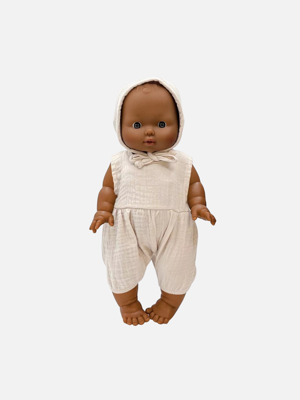 Baby doll wearing a beige outfit on a white background