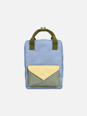 Small blue backpack with a yellow flap and green straps on a white background